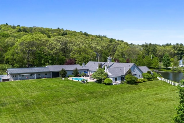 birds eye view of property with a view of trees