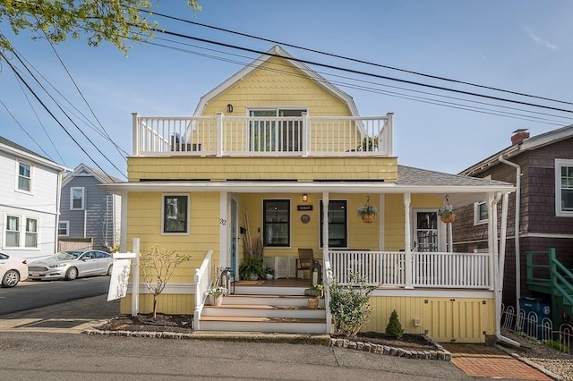 view of front of house with a porch and a balcony
