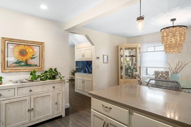 kitchen with an inviting chandelier, pendant lighting, recessed lighting, arched walkways, and dark wood finished floors