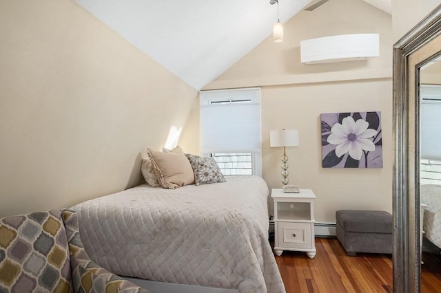bedroom with vaulted ceiling with skylight, multiple windows, an AC wall unit, and wood finished floors