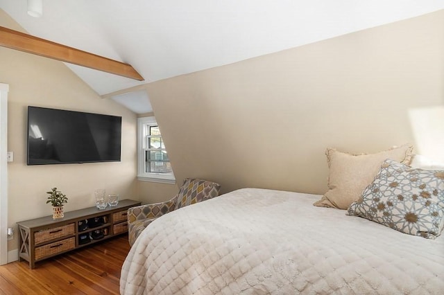 bedroom featuring baseboards, vaulted ceiling, and wood finished floors