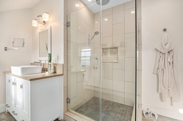 full bathroom with a shower stall and vanity