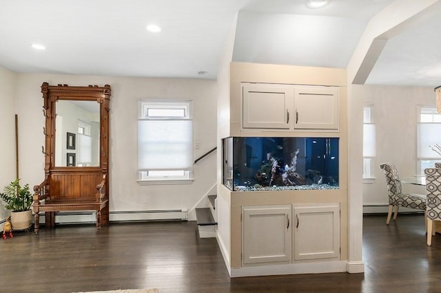 interior space featuring recessed lighting, baseboards, dark wood finished floors, and a baseboard heating unit