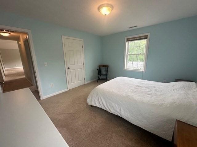 carpeted bedroom with baseboards