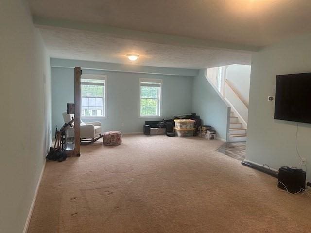 bonus room with carpet floors, stairway, and baseboards