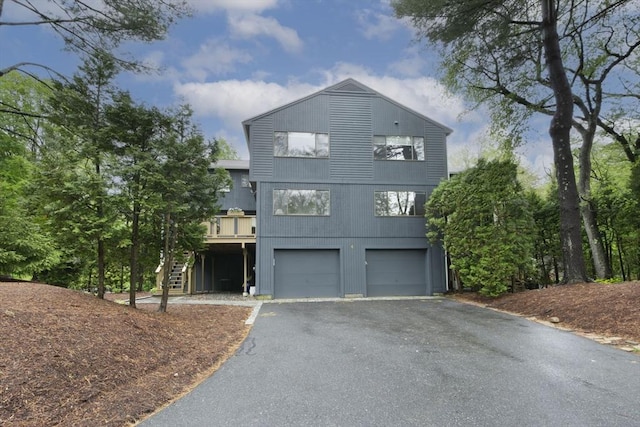 view of front of property with driveway, stairs, and an attached garage