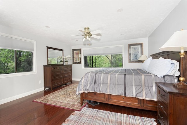 bedroom featuring hardwood / wood-style floors, baseboards, and ceiling fan