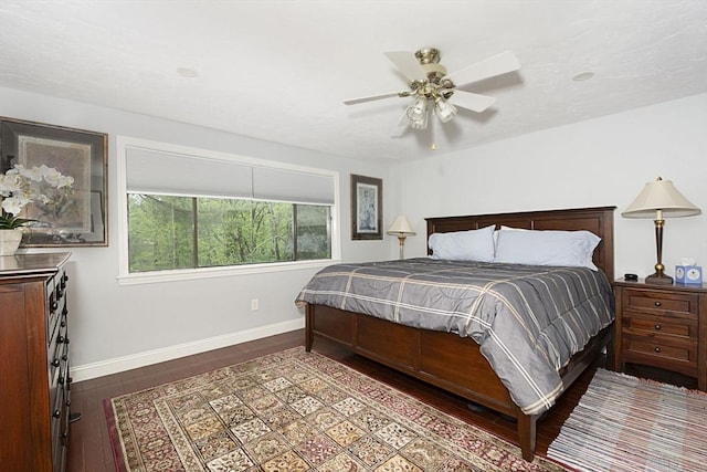 bedroom featuring wood finished floors, baseboards, and a ceiling fan