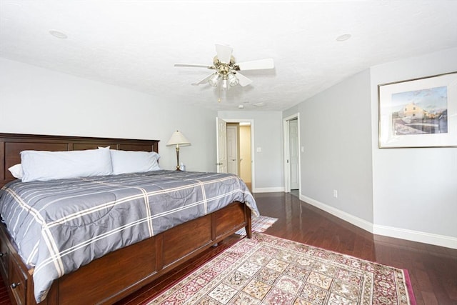 bedroom featuring baseboards, hardwood / wood-style floors, and a ceiling fan