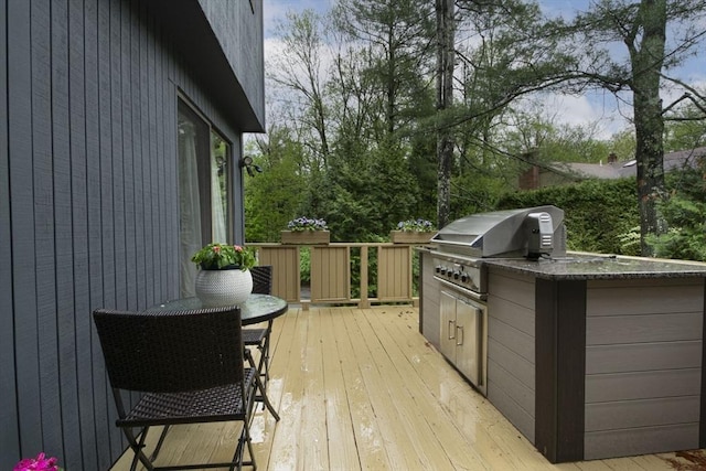 wooden terrace featuring a grill and area for grilling
