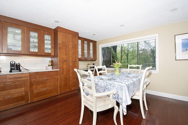 dining area featuring baseboards and dark wood-style floors