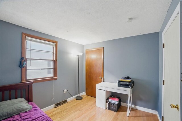 26 Hanna St, Quincy, MA 02169 - bedroom with light wood-style flooring, a textured ceiling, and baseboards