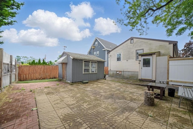 26 Hanna St, Quincy, MA 02169 - back of property with a patio, an outbuilding, and a fenced backyard