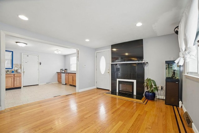 26 Hanna St, Quincy, MA 02169 - unfurnished living room with baseboards, light wood-style flooring, recessed lighting, and a fireplace