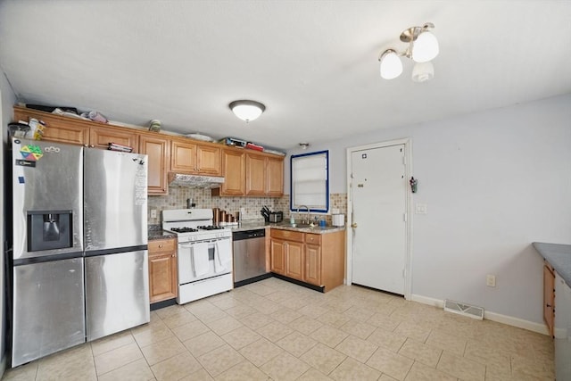 26 Hanna St, Quincy, MA 02169 - kitchen featuring appliances with stainless steel finishes, a sink, under cabinet range hood, baseboards, and decorative backsplash