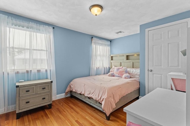 bedroom with light hardwood / wood-style floors