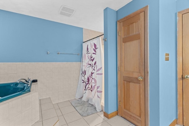 bathroom featuring tile patterned flooring and shower with separate bathtub