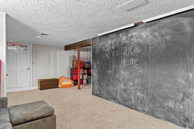 basement with carpet flooring and a textured ceiling