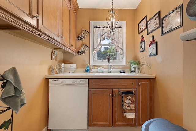 bar with white dishwasher, a sink, and hanging light fixtures