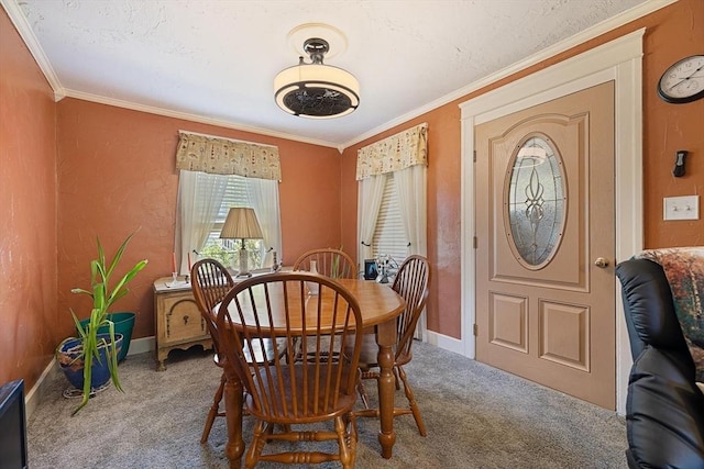 carpeted dining area with crown molding and baseboards