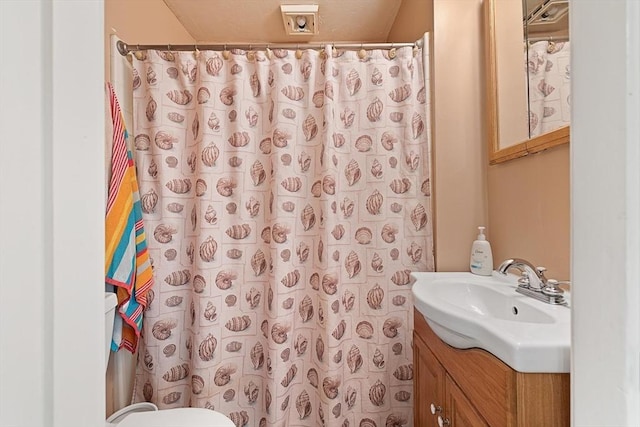 bathroom featuring vanity, a shower with curtain, and toilet