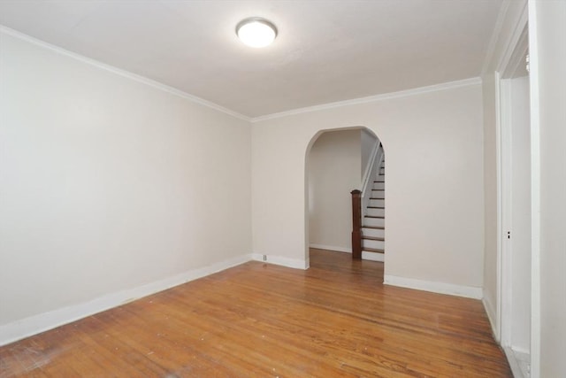 unfurnished room with hardwood / wood-style flooring and ornamental molding