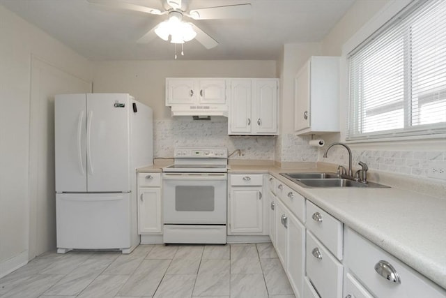 kitchen featuring white appliances, white cabinets, decorative backsplash, sink, and ceiling fan