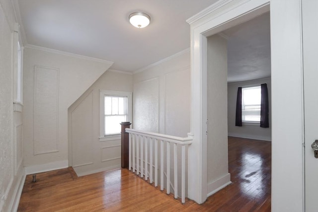 corridor with hardwood / wood-style flooring and crown molding