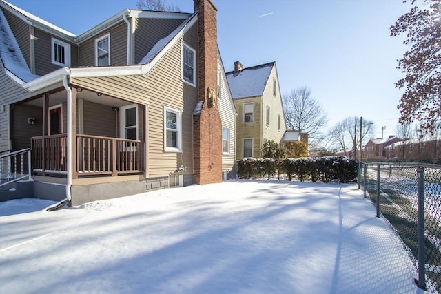 view of snow covered exterior with a porch