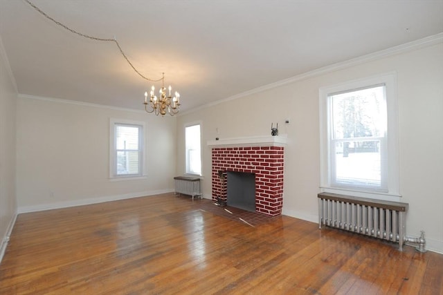 unfurnished living room with radiator heating unit, a healthy amount of sunlight, dark hardwood / wood-style floors, and ornamental molding