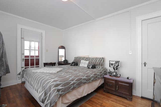 bedroom with dark hardwood / wood-style flooring and crown molding