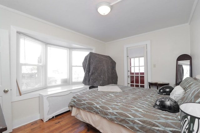 bedroom featuring dark hardwood / wood-style flooring and crown molding