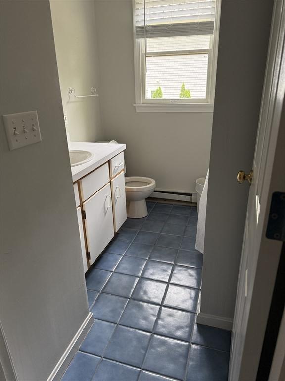183 Monomoscoy Rd, Mashpee, MA 02649 - bathroom with vanity, a baseboard heating unit, and tile patterned flooring