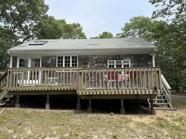 183 Monomoscoy Rd, Mashpee, MA 02649 - back of property with a wooden deck and roof with shingles