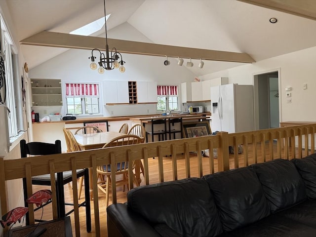 183 Monomoscoy Rd, Mashpee, MA 02649 - living area featuring a skylight, high vaulted ceiling, and wood finished floors