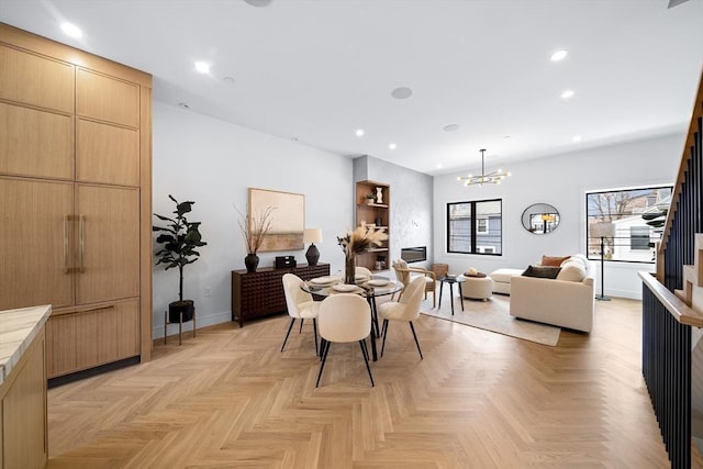 dining space featuring recessed lighting, a chandelier, and baseboards