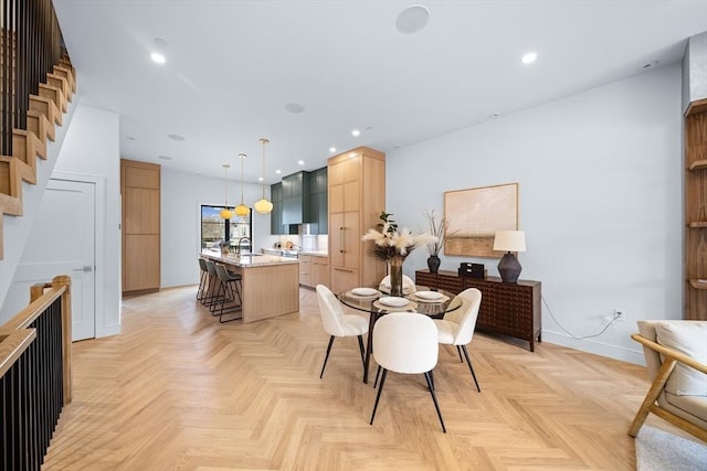 dining space featuring baseboards, stairway, and recessed lighting