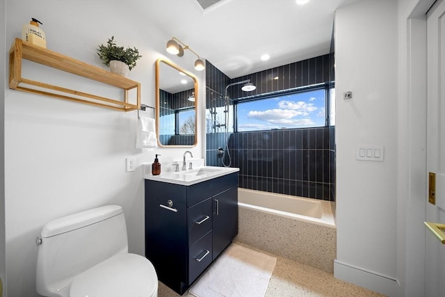 full bathroom featuring speckle patterned floor, toilet, washtub / shower combination, and vanity