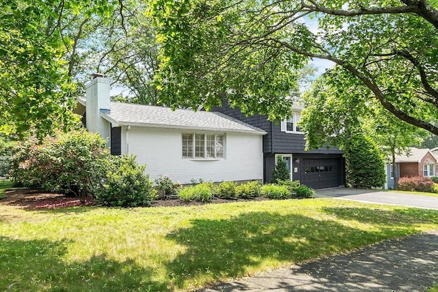 5 Summit View Dr, Swampscott, MA 01907 - split level home featuring asphalt driveway, a garage, a chimney, and a front lawn