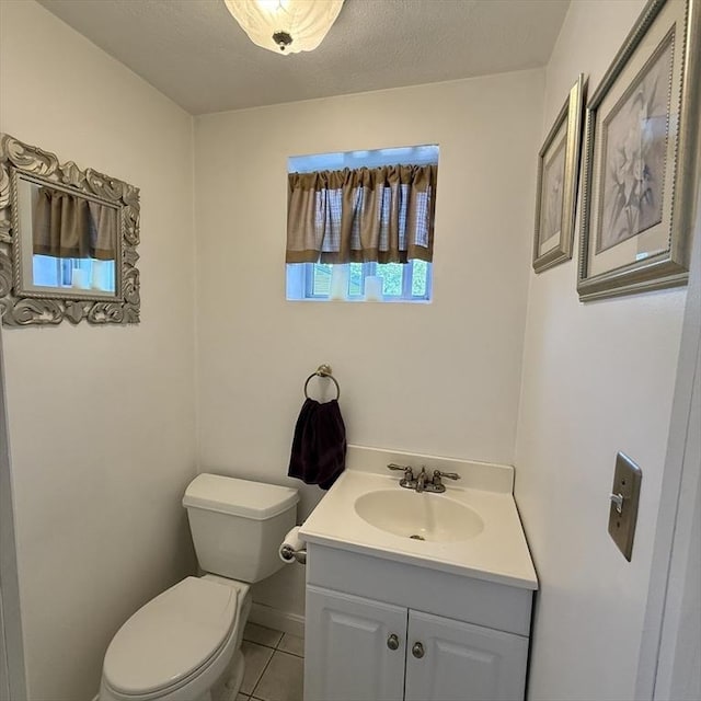 bathroom with vanity, toilet, and tile patterned floors