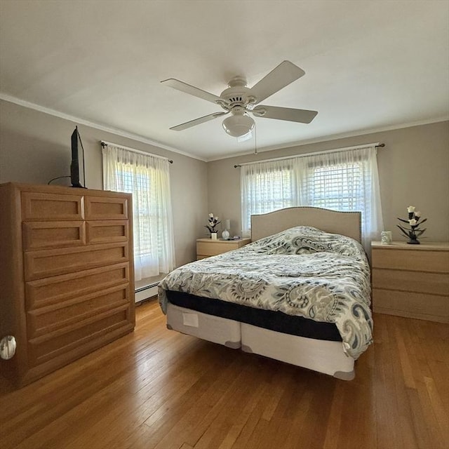 bedroom featuring a baseboard radiator, light wood-type flooring, ornamental molding, and a ceiling fan