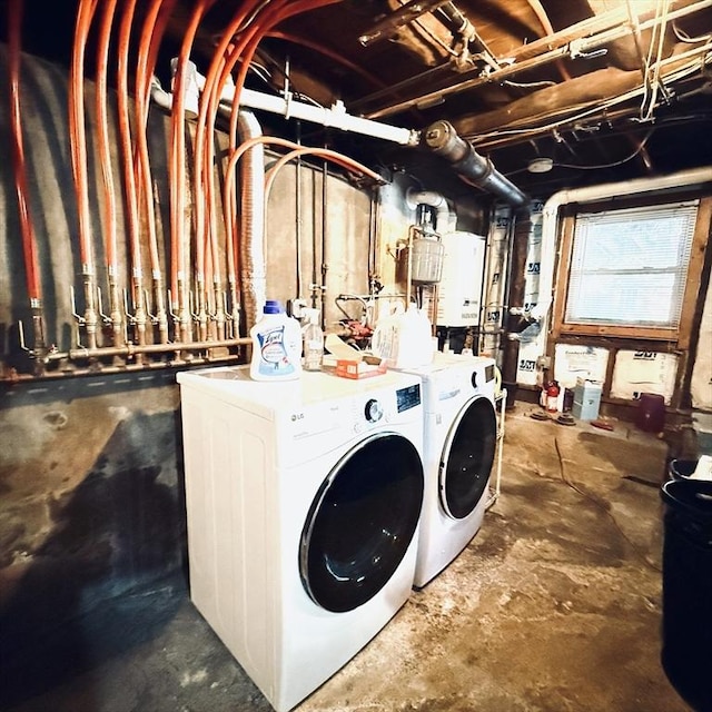 clothes washing area with washing machine and clothes dryer and tankless water heater