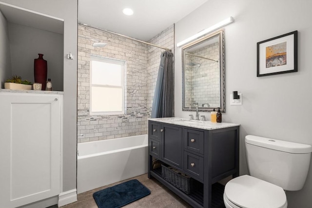 bathroom featuring toilet, shower / tub combo, and vanity