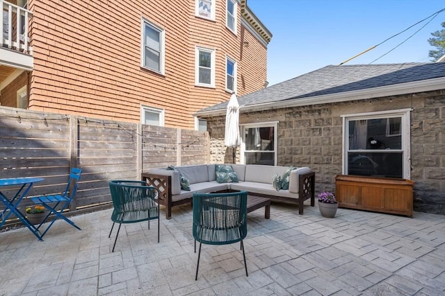 view of patio featuring outdoor lounge area and fence