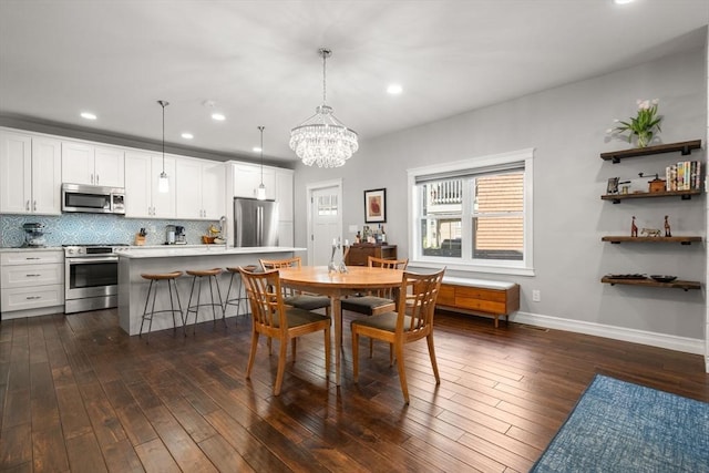 dining space with recessed lighting, baseboards, an inviting chandelier, and dark wood-style floors