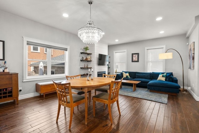 dining area featuring baseboards, recessed lighting, dark wood-style floors, and an inviting chandelier
