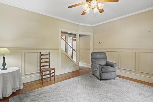 20 Houghton St, Webster, MA 01570 - sitting room featuring a decorative wall, wood finished floors, ceiling fan, ornamental molding, and stairs