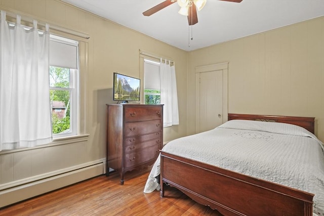 20 Houghton St, Webster, MA 01570 - bedroom with a baseboard heating unit, wood finished floors, and a ceiling fan