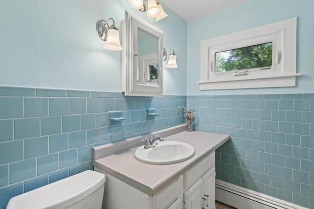 20 Houghton St, Webster, MA 01570 - half bath featuring tile walls, vanity, a baseboard heating unit, and a wainscoted wall