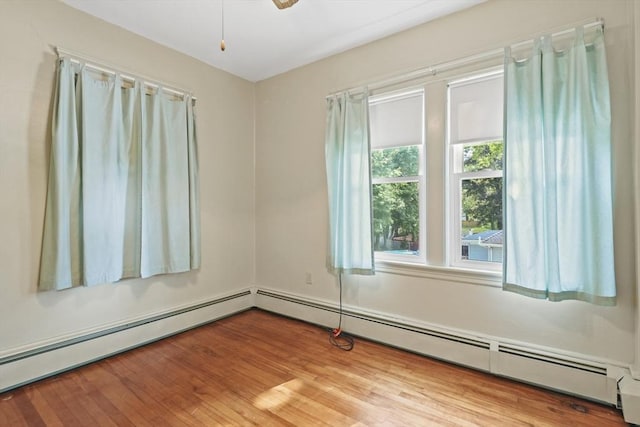 20 Houghton St, Webster, MA 01570 - unfurnished room with baseboard heating, wood finished floors, and ceiling fan